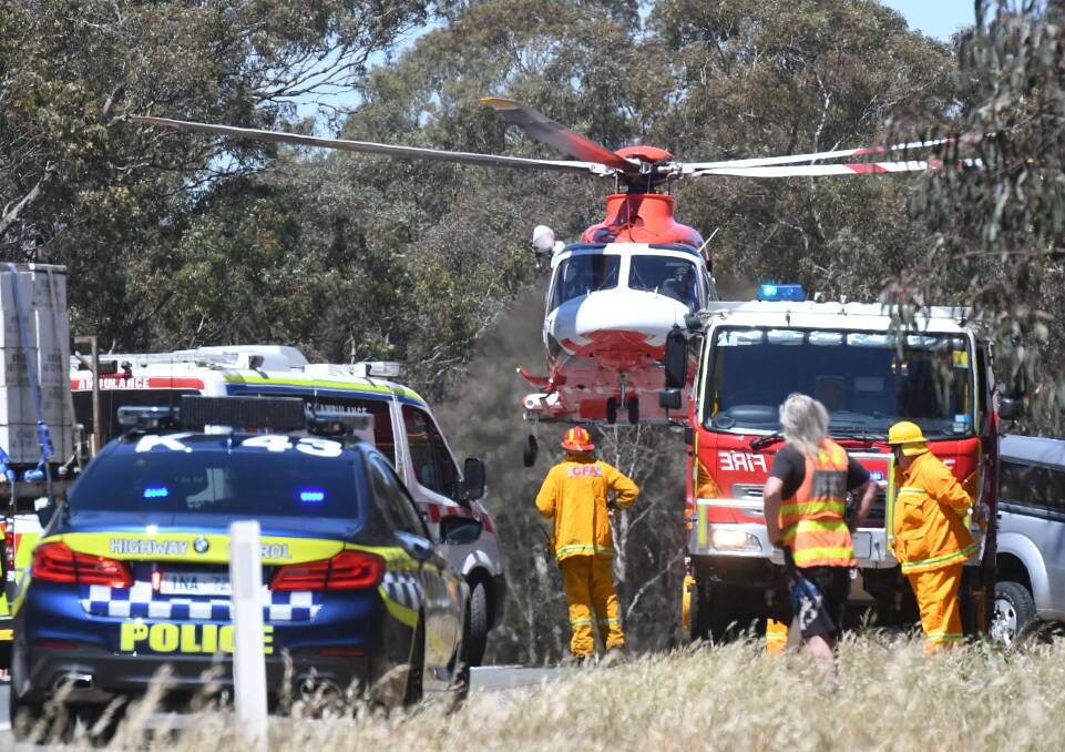 Emergency services at the scene of the fatal crash last year. Picture: NONI HYETT