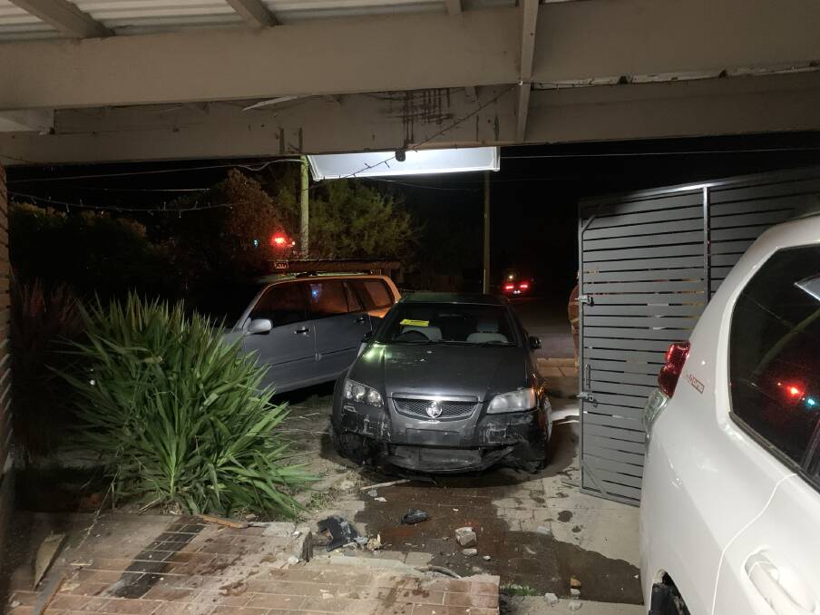 The grey Commodore which smashed into the home after 3am on Wednesday morning. Photos: Supplied