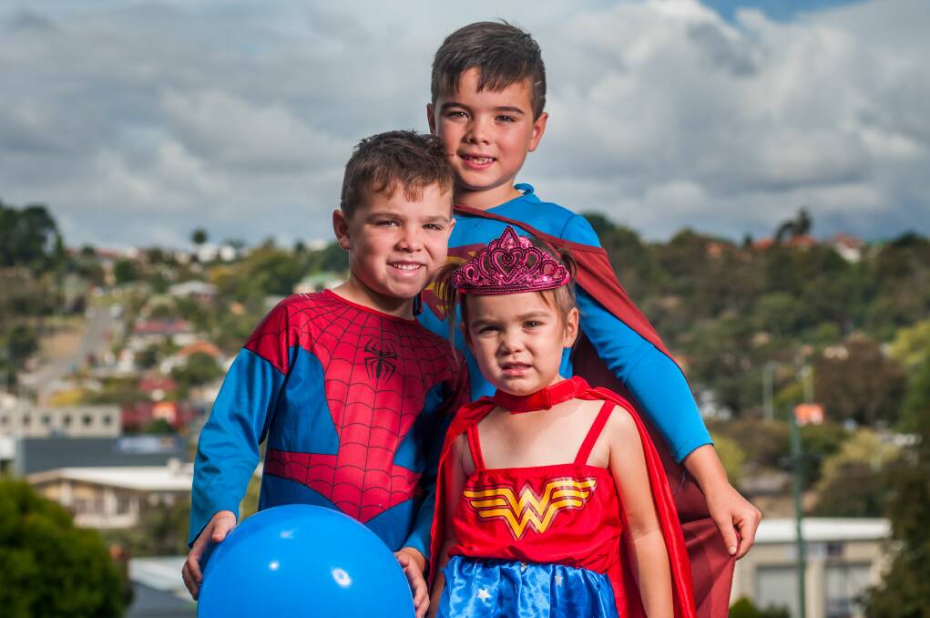 HERO: Stuart Innes, 6, of Launceston with brother Tim, 7, and sister Maggie, 2, will all particiapate in Saturday's Run For A Wish event dressed as superheros, raising money for sick children and teenagers. Picture: Phillip Biggs
