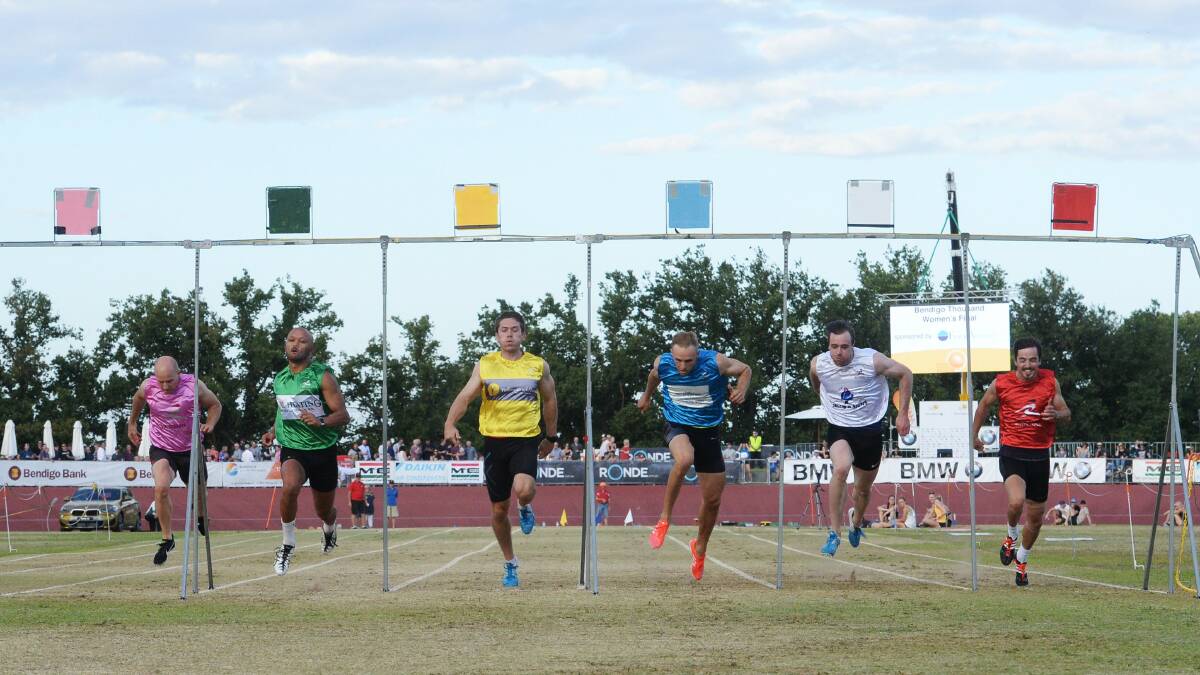 SUCCESS: Rupert Lugo, in green, dashes to victoiry in the Bendigo Thousand 120m handicap at the Tom Flood Sports Centre. Picture: DARREN HOWE