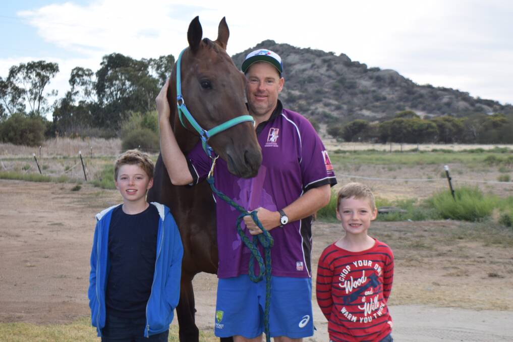 HAPPY FAMILY: Chris Cain with sons Fletcher, 10, and Harry, 7, and Travelnpast. Picture: KIERAN ILES