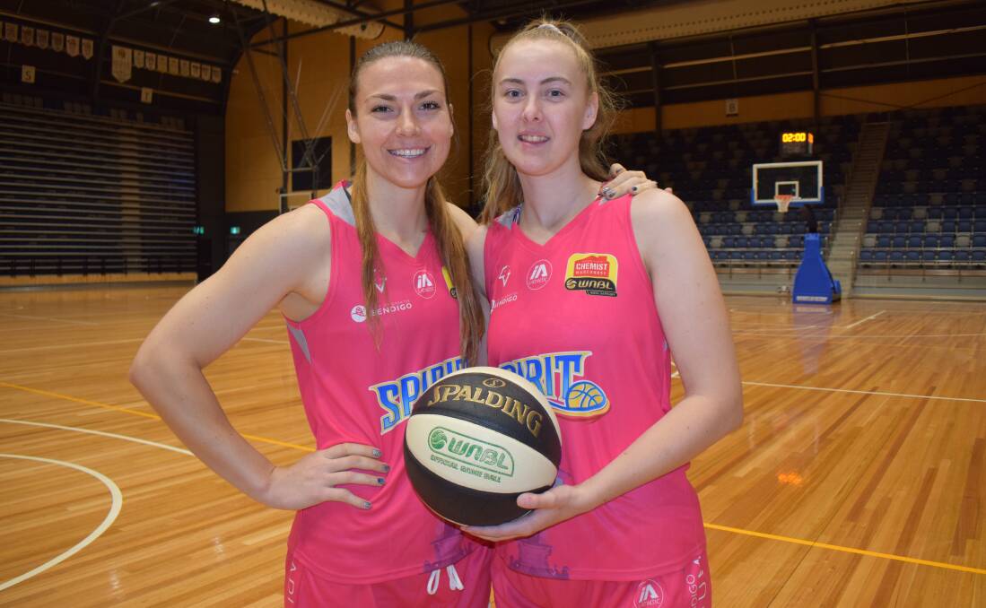 SPECIAL CAUSE: Teige Morrell and Demi Skinner don the jerseys the Spirit will wear during pink round. Picture: KIERAN ILES