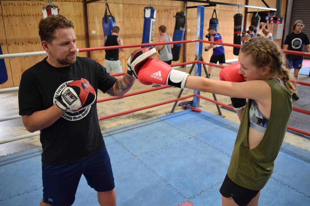 Milli with her coach Danniel Burton at the Hit Factory gym in Golden Square. Picture: KIERAN ILES