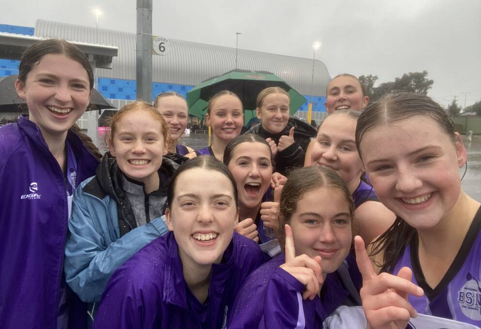 The BSNA's 15-and-under girls celebrate their semi-final win in the rain at the Golden City Netball Association courts.