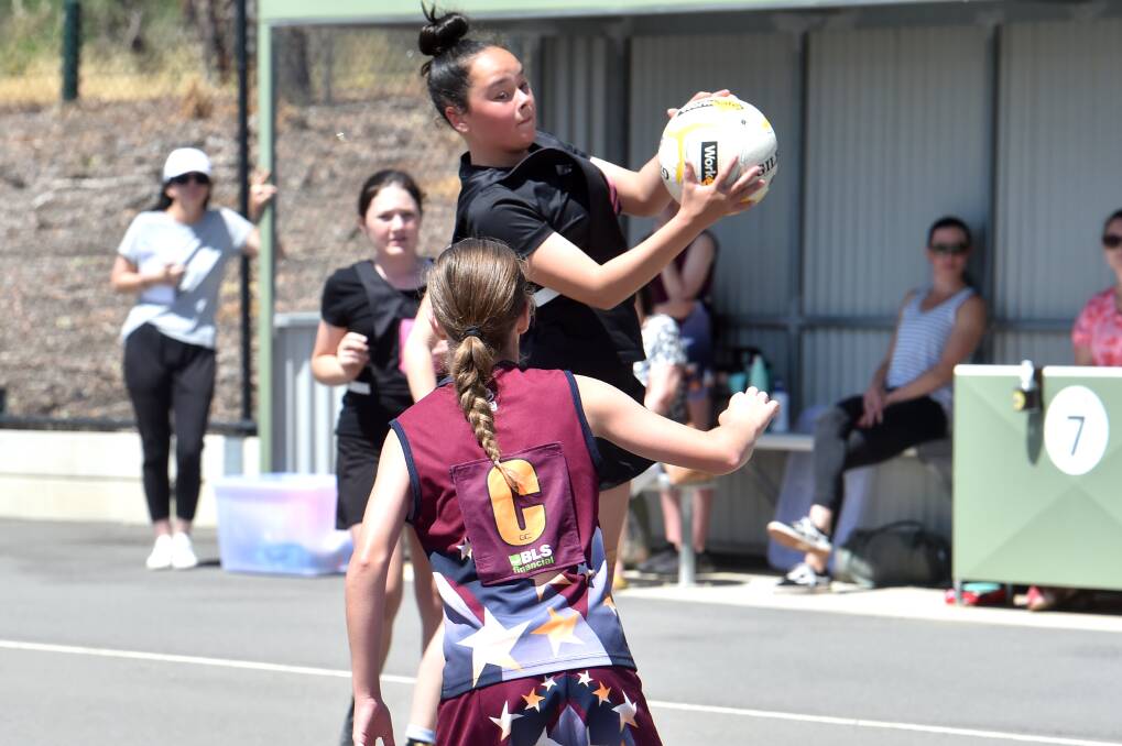 SAFE HANDS: Panthers (black) defeated St Therese's Tippett in 13-and-under section one. Picture: DARREN HOWE