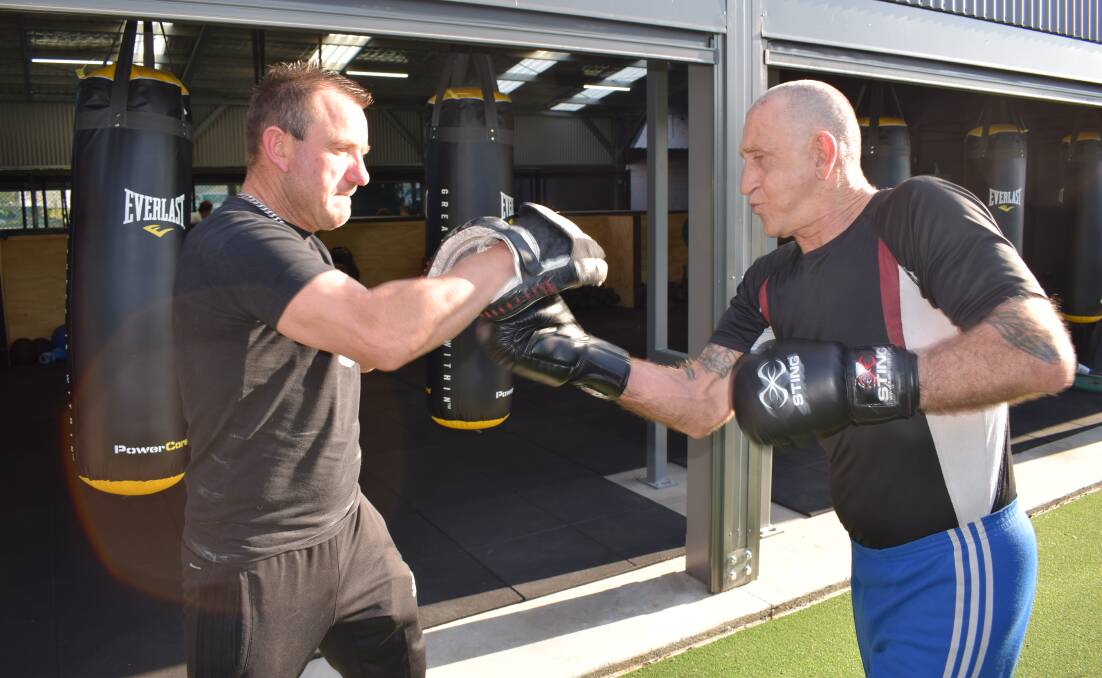 Bendigo boxing coach Frank Pianto with Victorian masters boxing champion Garry Austin. Picture: KIERAN ILES