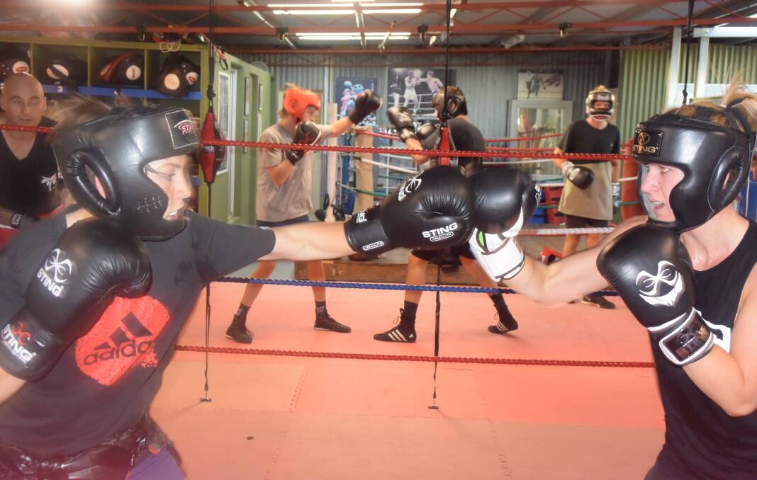 Lorrinda Webb spars with young boxer Corey Roberts at Connollys gym. Picture: KIERAN ILES