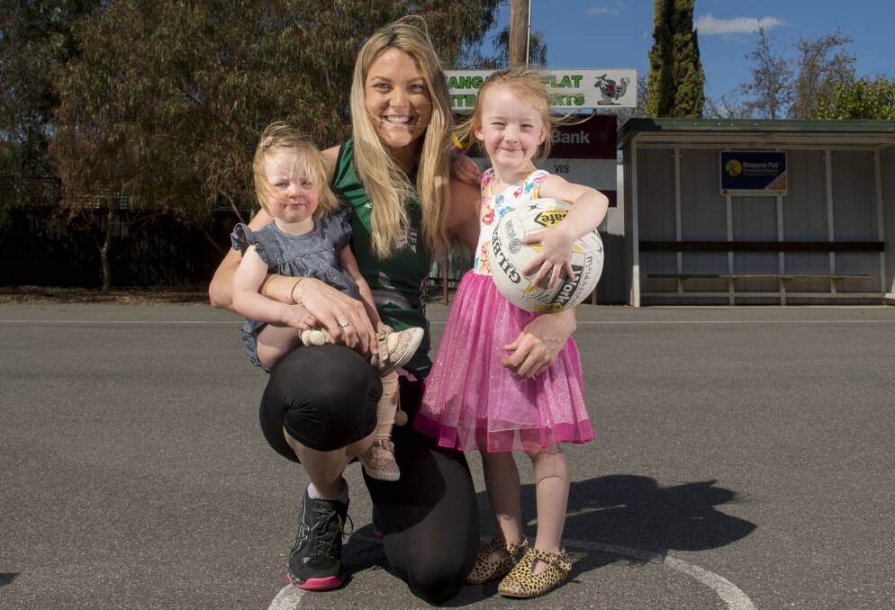 GOING STRONG: Alicia McGlashan, with daughters Olivia and Chloe, will be playing in her 10th Bendigo Football Netball League A-grade grand final for Kangaroo Flat on Saturday. Picture: DARREN HOWE