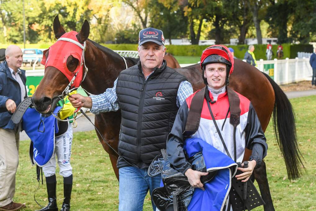Jockey Michael Poy and owner Steve Chapman with Haystacks Calhoun after Monday's win. Picture: BRETT HOLBURT/RACING PHOTOS
