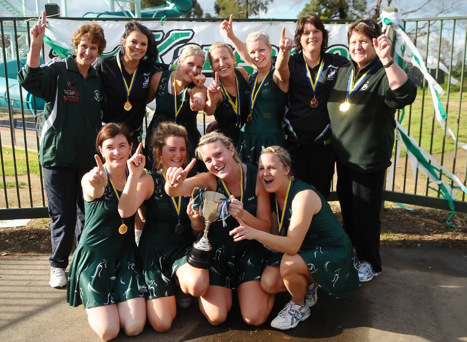 BIG INFLUENCE: Legendary Kangaroo Flat coach Carol Bingham (back, right) celebrates success with her premiership-winning line-up in 2009. Picture: LAURA MAKEPEACE