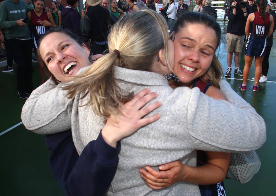 Erica and Brianna Dalrymple-Monro get a hug for mum following the 2019 grand final.