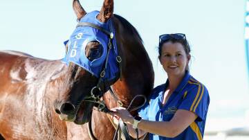 Strapper Emma Pontelandolfo with Buchan Hoaks, who won for the sixth time in his career, on Sunday at Wangaratta. Picture: RACING PHOTOS