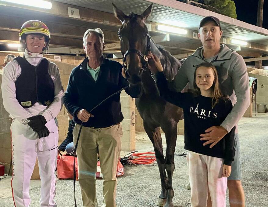 Driver James Herbertson, winning trainer Gary Donaldson, and Pacers Bendigo syndicate member Josh Mould, with daughter Zara, celebrate a win with Leigha Miller on 2022 Mildura Pacing Cup night.