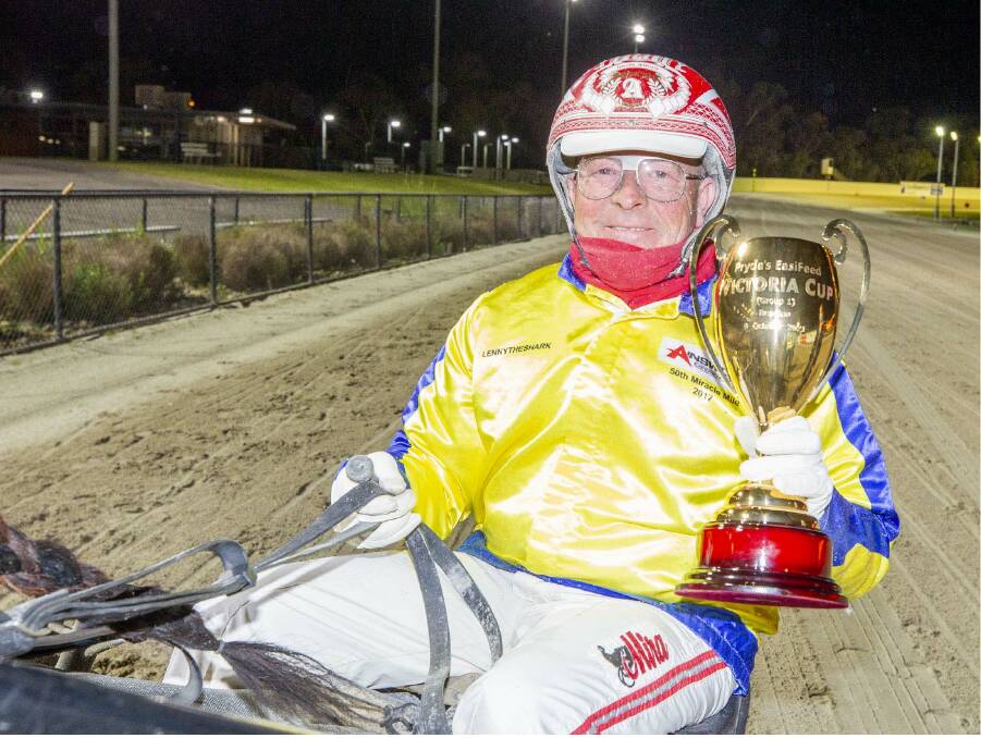 Chris Alford grasps the Group 1 Victoria Cup following his win aboard the David Aiken-trained Max Delight in Saturday night's race at Lord's Raceway in Bendigo. Picture: STUART McCORMICK