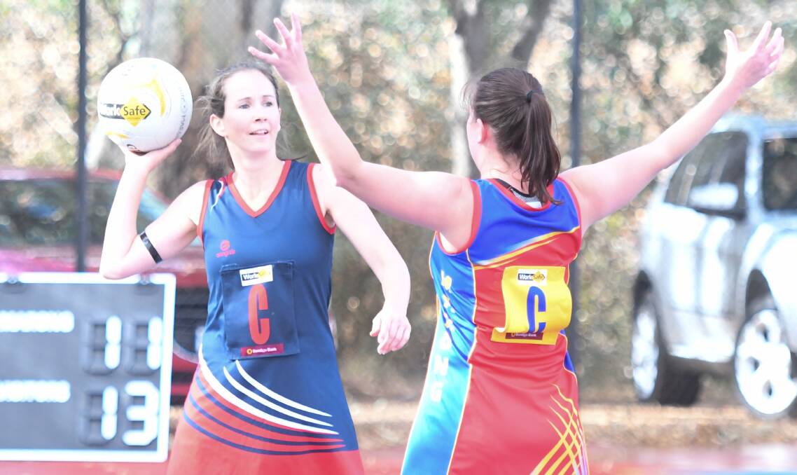 IN CONTROL: Calivil United centre Erin Boyd searches for a team-mate under pressure from Marong's Sarah Kellett at Malone Park. Picture: ADAM BOURKE