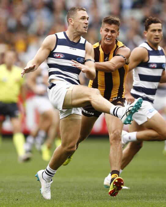 Joel Selwood kicks the ball under pressure during Monday's match between Hawthorn and Geelong at the MCG. Picture: AAP IMAGE/DANIEL POCKETT
