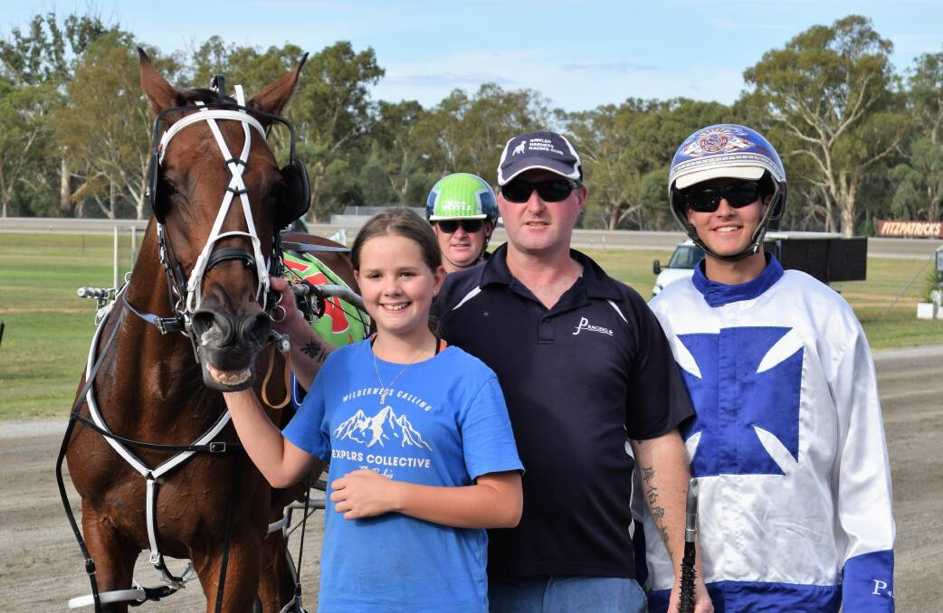 Ryan Sanderson (right) with Kyabram trainer Paul Fidge and his daughter following their Ames Australasia Pace Final win with Imperials Reason at Charlton on Sunday. Picture: KIERAN ILES