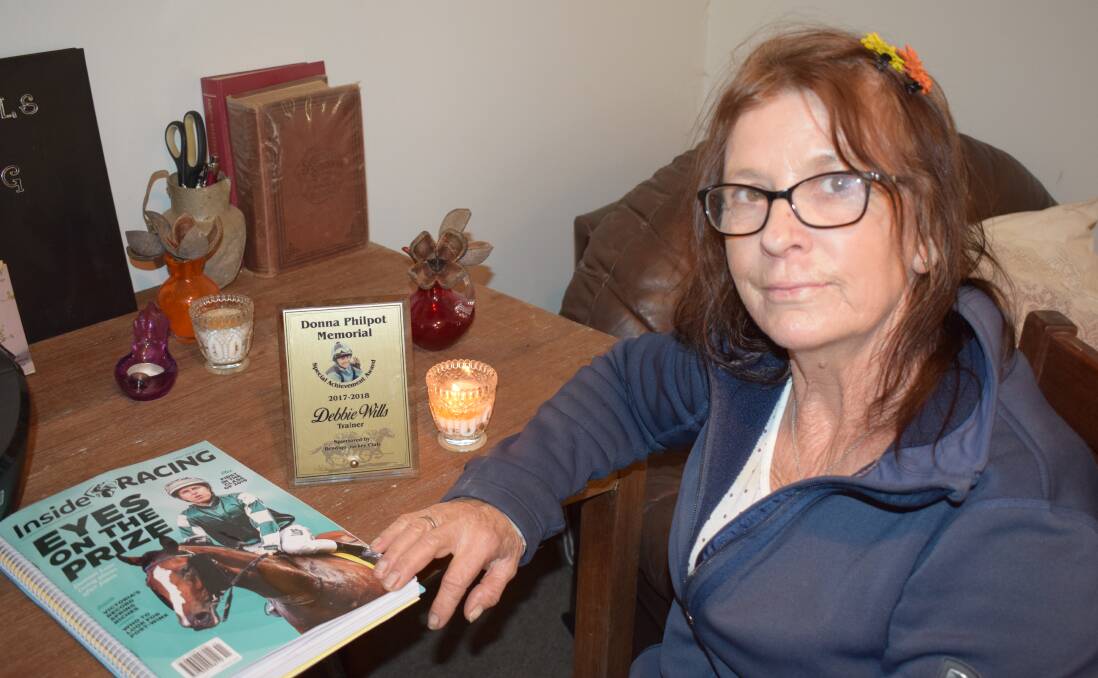 Debbie Wills and her tribute to former Bendigo racing identity Donna Philpot inside her Bagshot home. Picture: KIERAN ILES