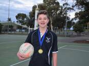 Will Whiteacre with the gold medal he won at the Australian Men's and Mixed Netball Association National Championships in Adelaide last month. Picture: KIERAN ILES