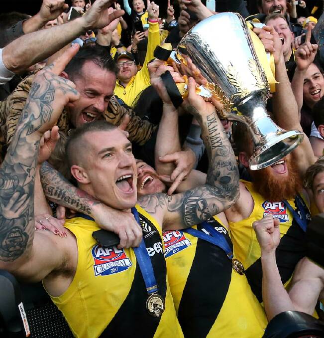 CHERISHING THE MOMENT: Dustin Martin and his premiership team-mates Kamdyn McIntosh and Nick Vlastuin celebrate their 2017 AFL Grand Final win with fans. Picture: WAYNE LUDBEY
