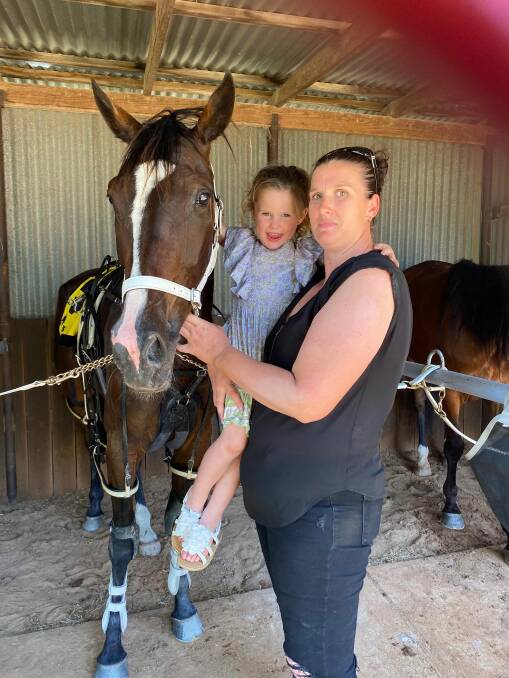 Tamara Markham and daughter Bonnie with Riverina Flash following the six-year-old pacer's win at Boort on Monday. Picture by Andrea O'Gorman
