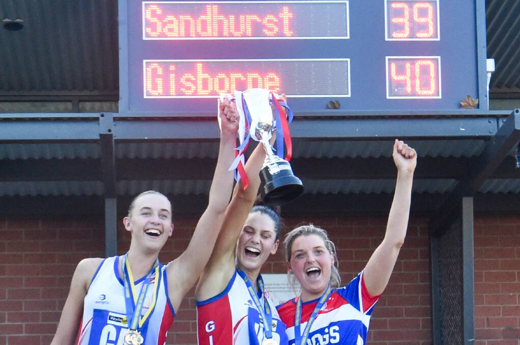 Co-captains Claudia Mawson and Kirby Elliott and coach Tarryn Rymer hold the 2023 premiership cup aloft. Picture by Darren Howe