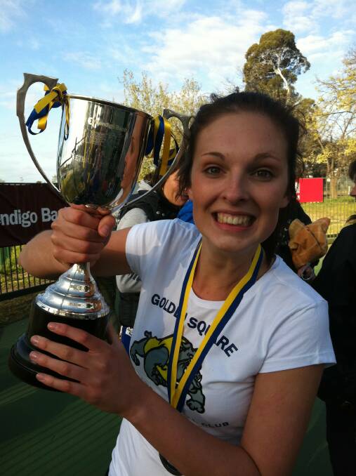 A young Jess Geary holds the premiership trophy following Golden Square's 49-42 triumph over Sandhurst at the QEO in 2011.
