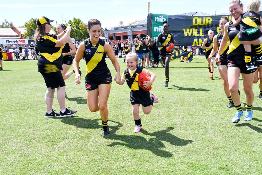 BACK HOME: Grace Campbell runs on to the QEO before Richmond's AFLW clash against Geelong in February. Picture: NONI HYETT