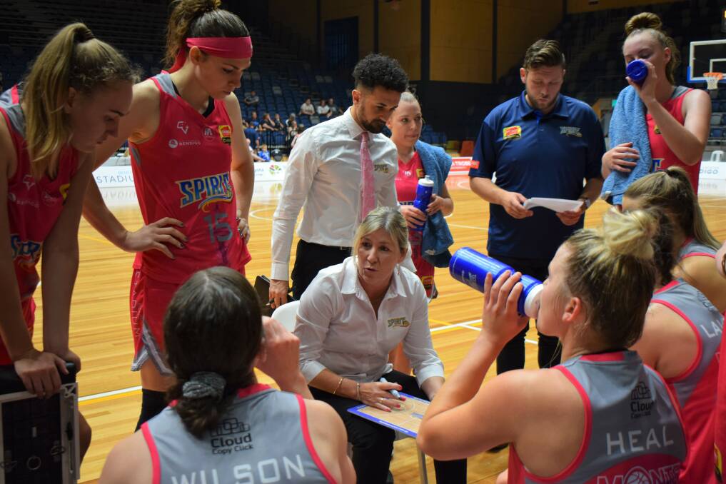 INSTRUCTIONS: Tracy York addresses her team at quarter time of Saturday night's clash against Southside Flyers. Picture: KIERAN ILES