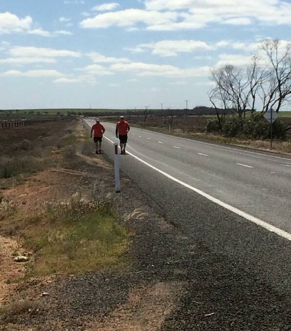 Brad McKenzie and Craig Spiller trek along the Sunraysia Highway, near the Mallee town of Tempy. Picture: Facebook