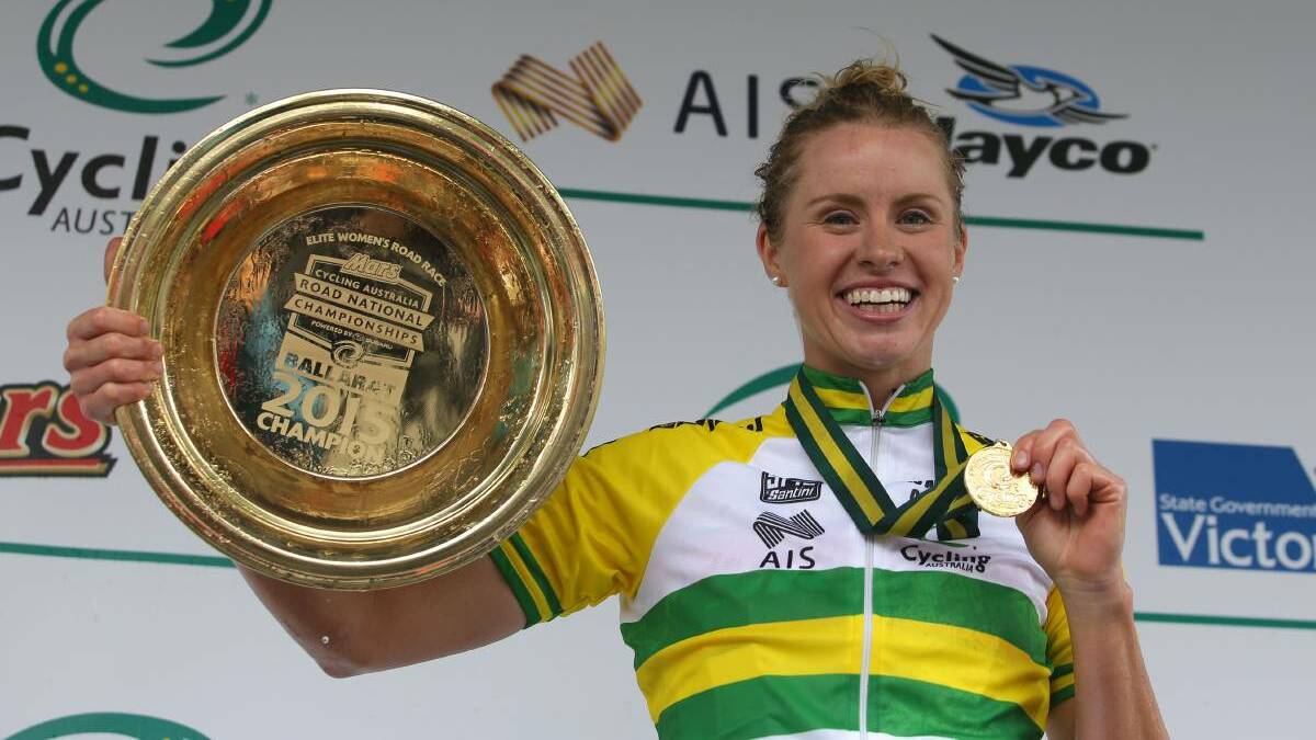 GOLD: Bendigo's Peta Mullens raises the trophy and medal after her victory in the women's elite road race at the national cycling championships. Picture: CYCLING AUSTRALIA