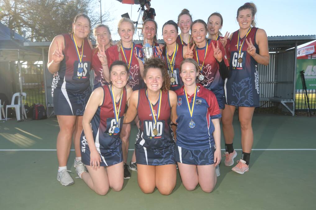 Williams and her premiership team-mates and coaches. Picture: NONI HYETT