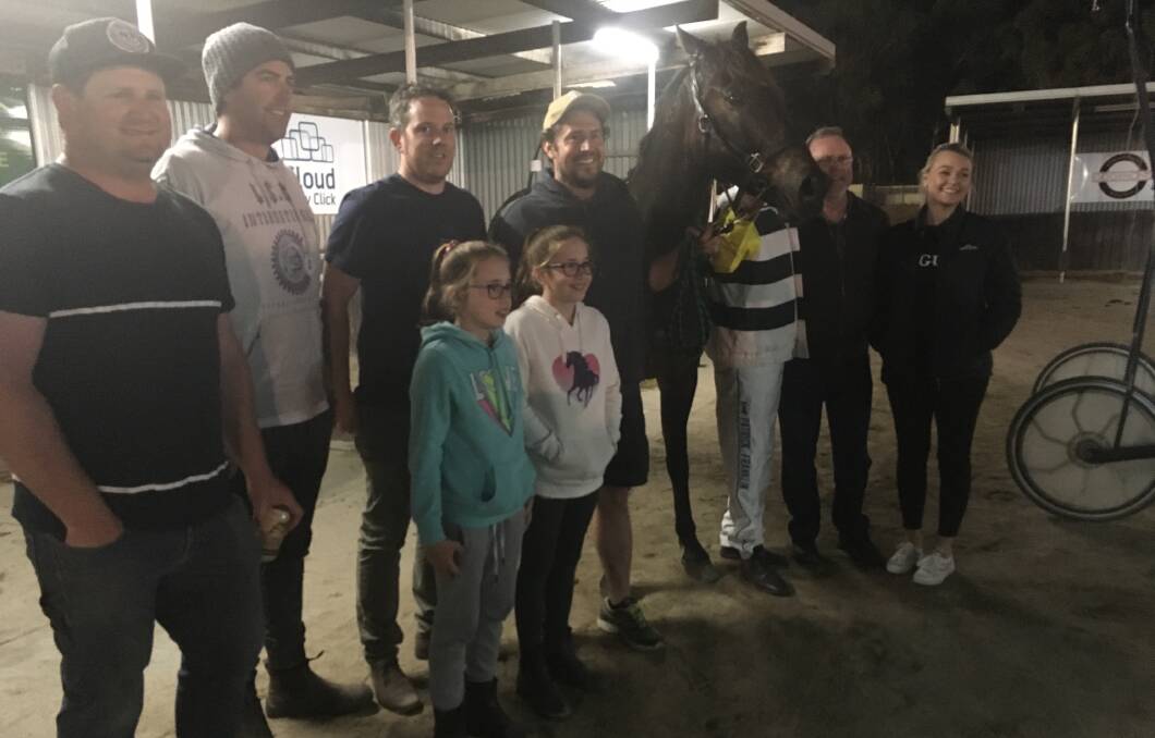 The connections of Terrorlean gather after the six-year-old gelding's win at Lord's Raceway on Tuesday night. 