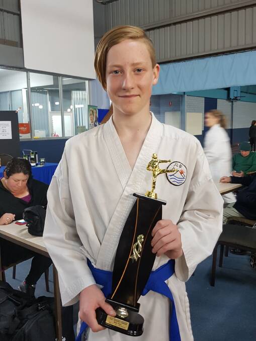 Hamish Johnson with his trophy for winning the single kata boys 12-13 years old 10-5th kyu at the Victorian Regional Karate Championships.