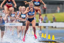 Bendigo University's Abbey Reid lands in the water race on her way to bronze in the  under-17 2000m steeplechase on Wednesday. Picture by Scott Sidley
