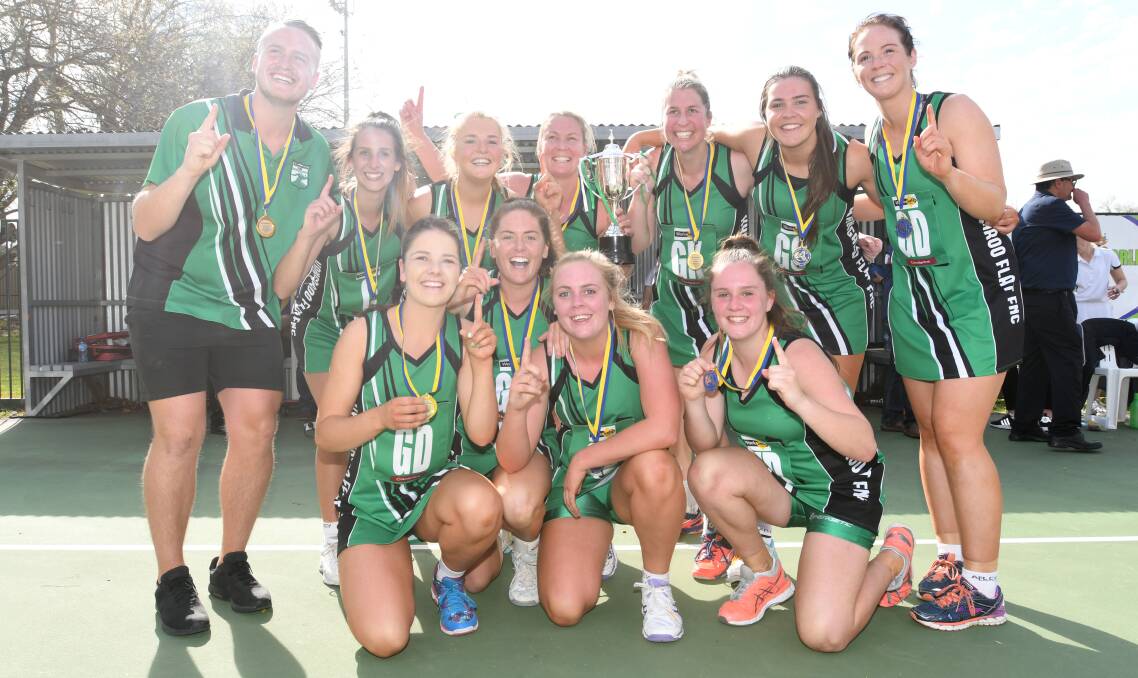 Kangaroo Flat's victorious A-reserve premiership team celebrates a win in 2018. Several players from the team will be chasing back-to-back flags. Picture: NONI HYETT