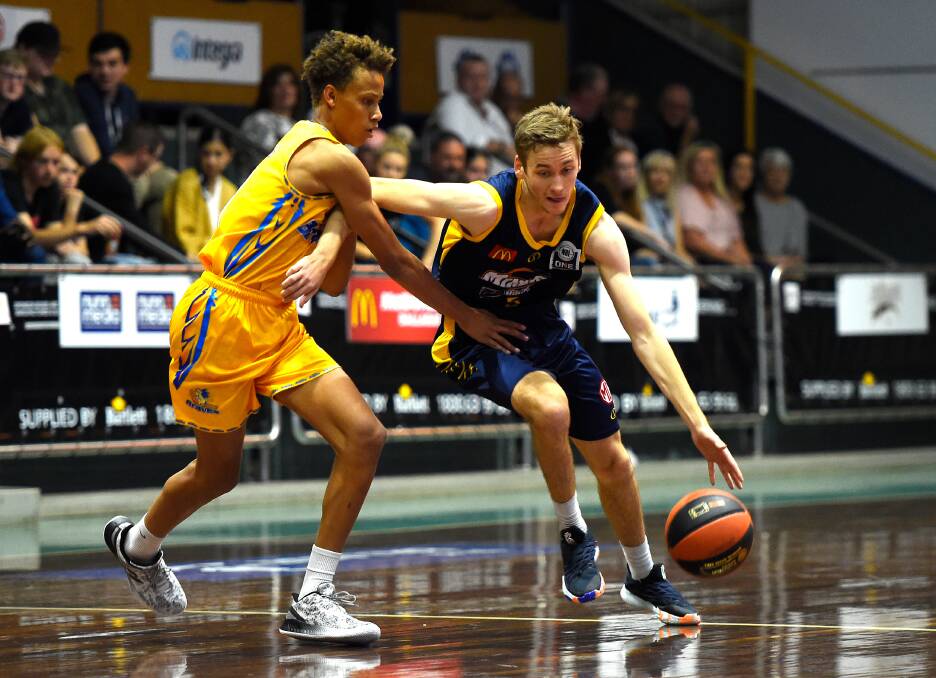 Braves youngster Dyson Daniels makes life difficult for Bendigo Miners' guard Sam Short. Daniels ended Saturday night's game with six points, three assists and a steal. Picture: ADAM TRAFFORD/BALLARAT COURIER