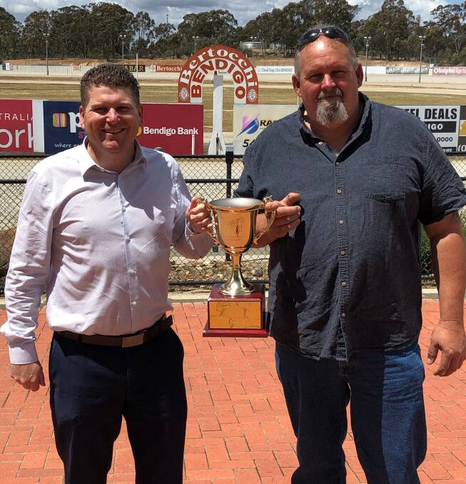 Bendigo Harness Racing Club general manager Erik Hendrix with Pat Bourke, from Bourke fencing, and the Anniversary Cup/