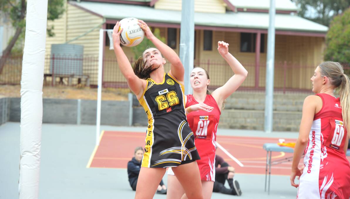 STRETCH: Kyneton's Jessica Mangan reaches high for a ball during Saturday's clash against South Bendigo at Harry Trott Oval. Picture: NONI HYETT