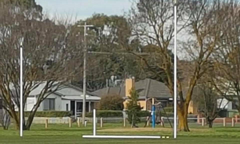 A damaged goal post lies on the ground at Kyneton.