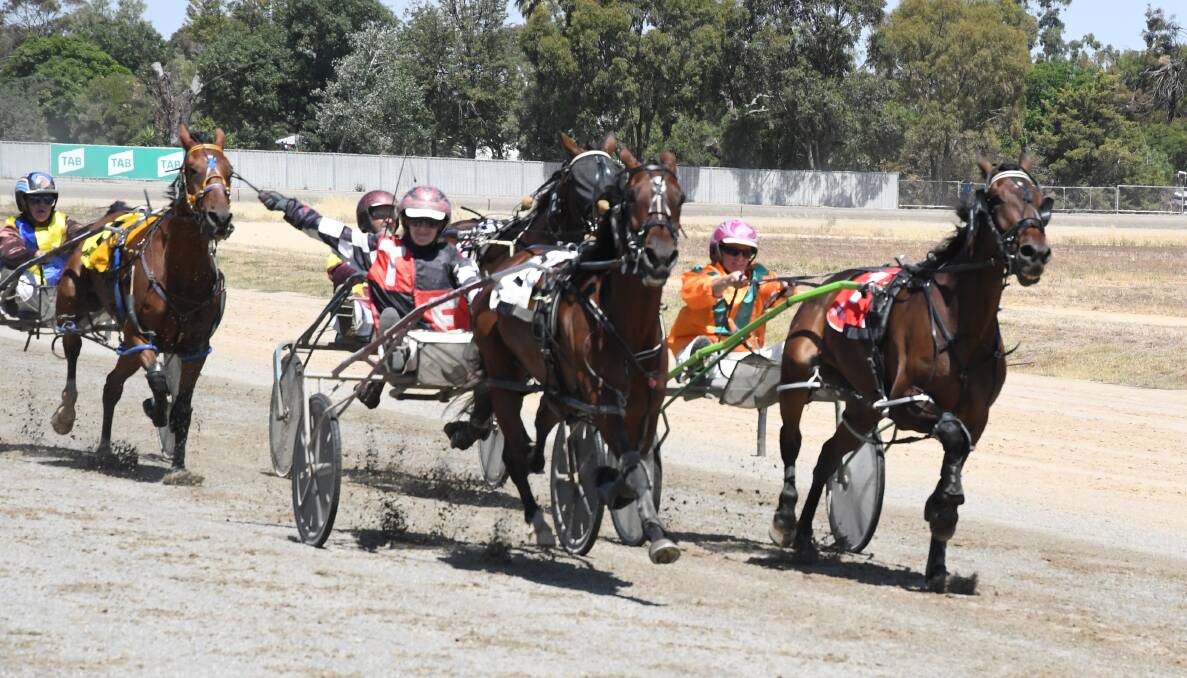 Tayla French raises her whip as a salute to her father Terry during her win aboard Nelbell. Picture: KIERAN ILES