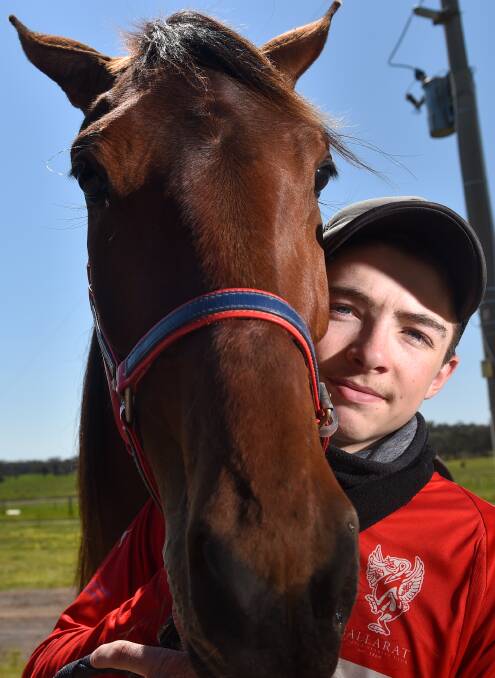 ON THE RISE: Jordan Leedham with the three-year-old filly More Than A Woman, who won at Terang on September 30, with the youngster in the sulky. Picture: DARREN HOWE