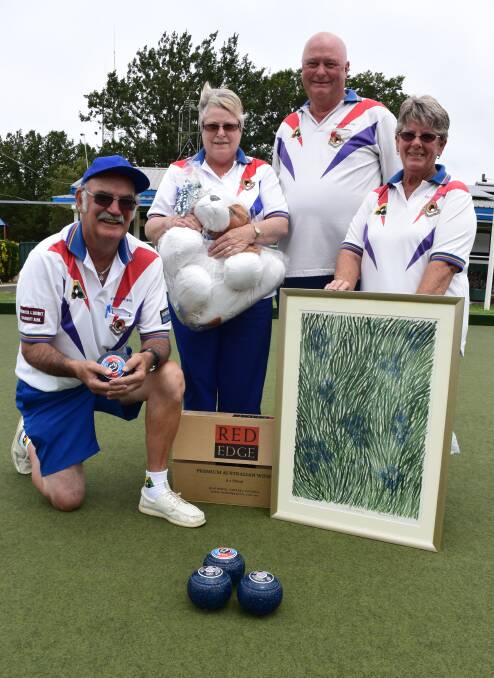 BOWLING FOR A FRIEND: Greg Speirs, Eileen O'Brien, Brian Taylor and Lorraine Speirs with some of the items available as prizes or for auction, including a framed 'blue cornflower' print donated by Motor Neurone Disease Victoria. Picture: KIERAN ILES