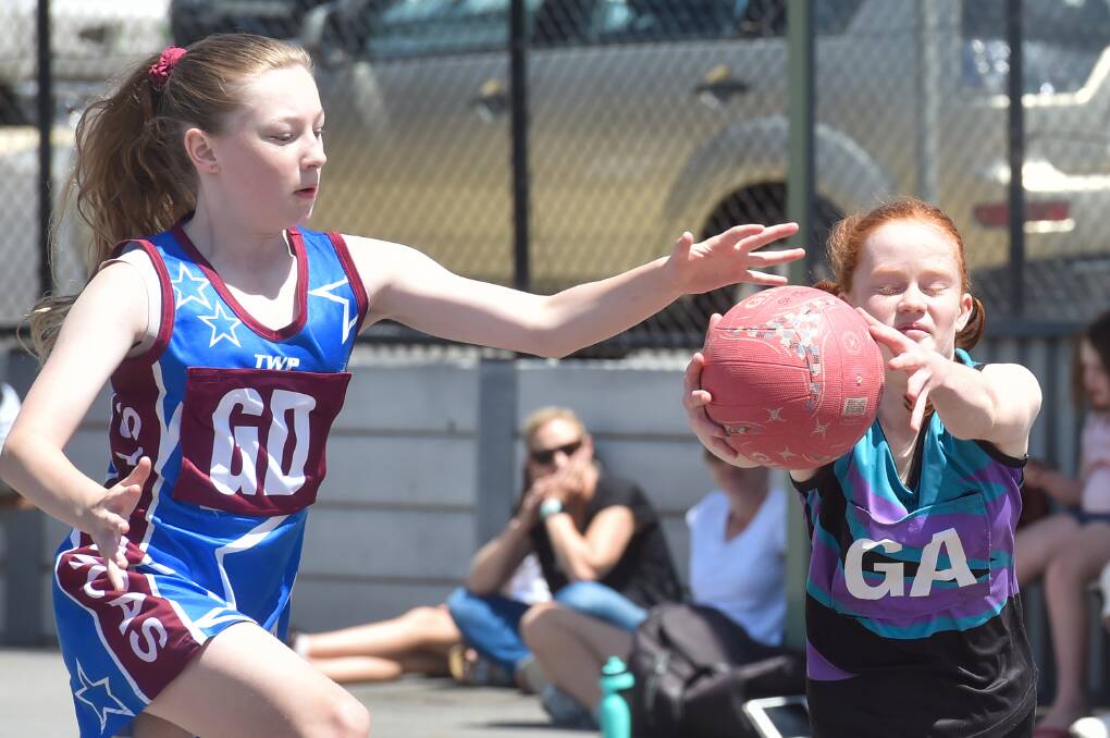 THRILLER: St Monica's Maroon and Lockwood Purple produced a nail-biter in the 13-and-under section two grand final, with St Monica's prevailing by just three goals (17-14). Picture: DARREN HOWE