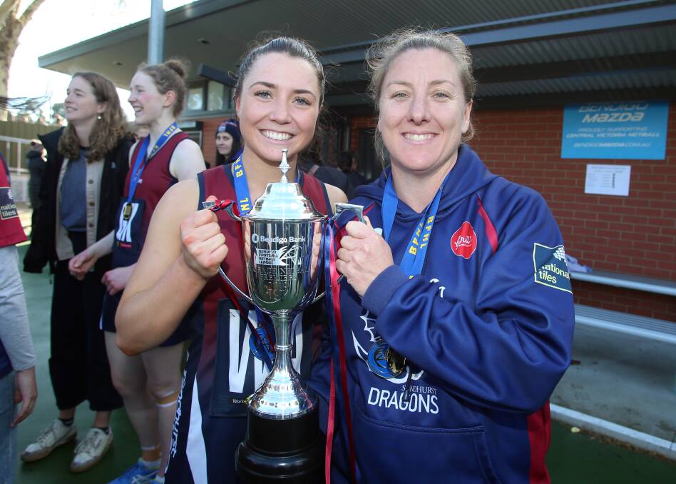 THREE IN A ROW: Star Sandhurst midcourter Meg Williams and coach Tamara Gilchrist hold the 2019 BFNL A-grade premiership cup following their win over Kangaroo Flat. The Dragons will be chasing four straight flags in 2021. Picture: GLENN DANIELS