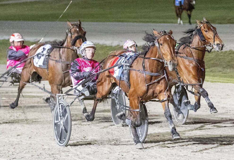 BRILLIANCE IN MOTION: Ladies In Red, driven by David Moran, charges to victory in last Saturday night's $150,000 Group 1 Victoria Oaks at Bendigo's Lord's Raceway. Picture: STUART McCORMICK