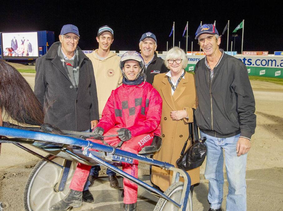 Ryan Sanderson celebrates with the connections of Radius at Tabcorp Park Melton last Saturday night. Picture: STUART McCORMICK 