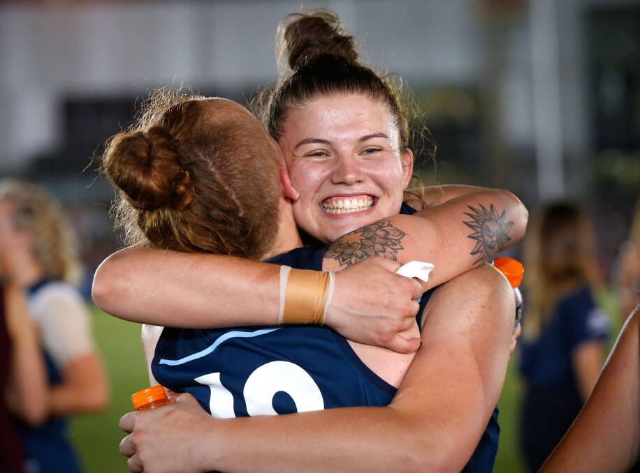 Bella Ayre of the Blues hugs Tilly Lucas-Rodd after Carlton's round one win over Collingwood. Picture: ADAM TRAFFORD/AFL MEDIA/GETTY IMAGES