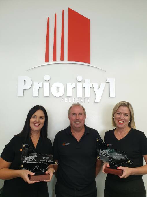 Priority 1 Property Bedndigo's Annie Tarr, Chris Garlick and Louise Svensen hold the Central Victorian Trotting and Pacing Championship trophies, which will be presented at Wedderburn on Sunday.