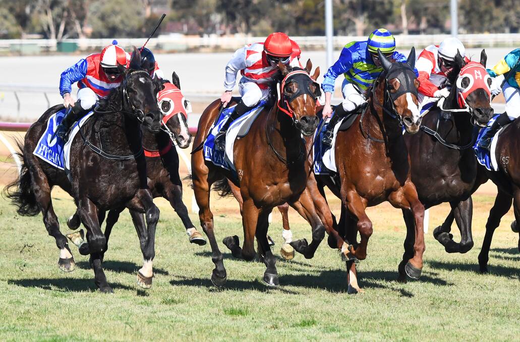 Air Defence, ridden by Damien Thornton (in the red and white Fliedner Racing colours), surges through for a win at Swan Hill in June this year. Picture; RACING PHOTOS